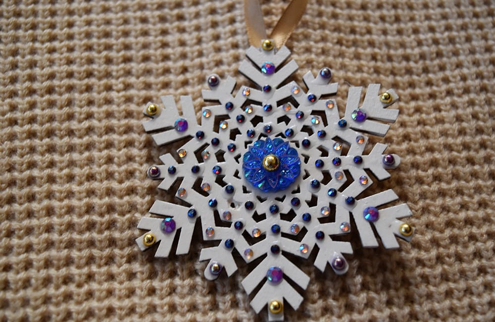 A snowflake ornament is sitting on the floor.