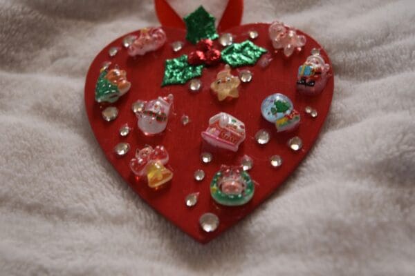 A red heart with many different decorations on it.