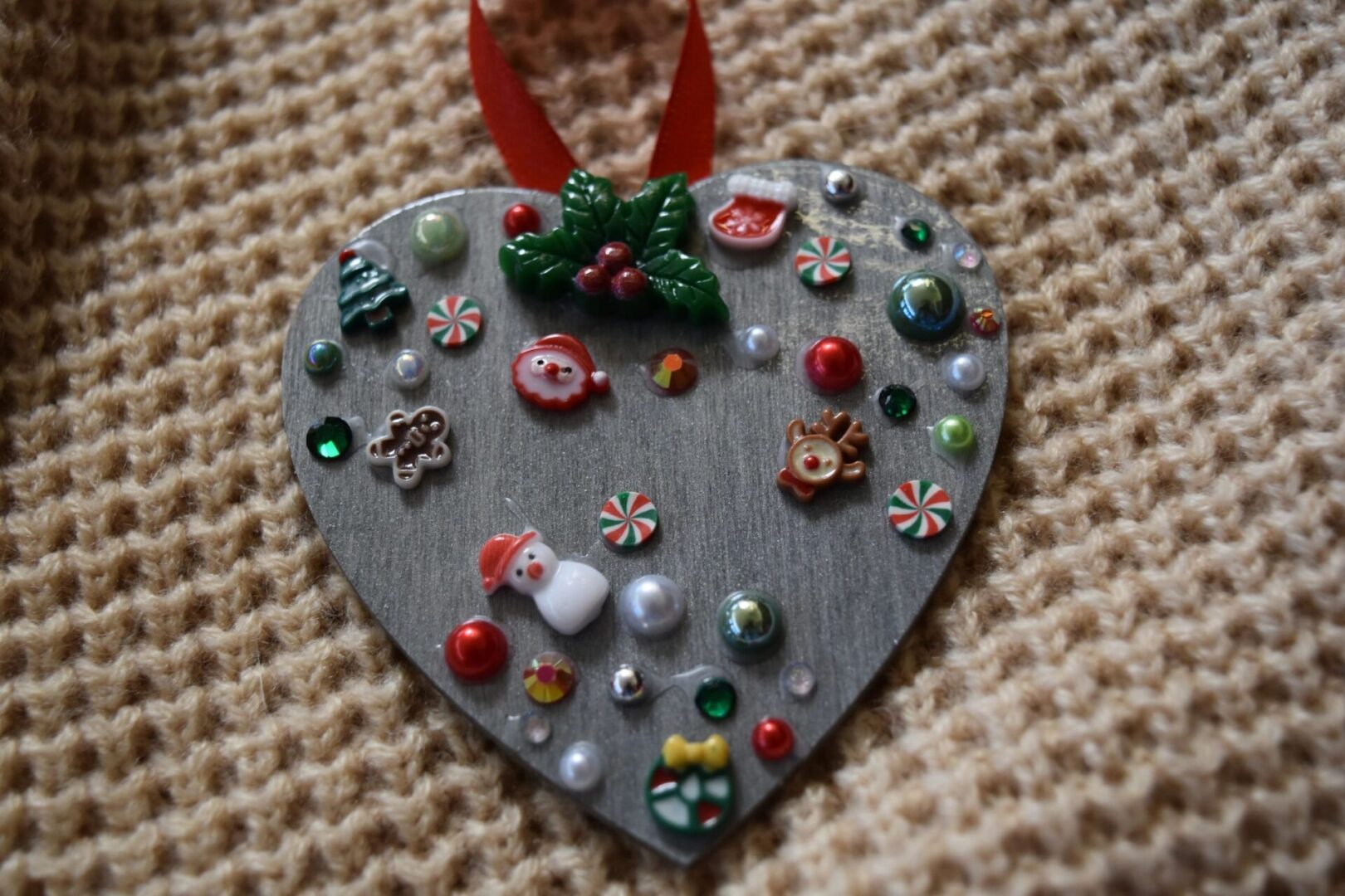 A heart shaped ornament with various decorations on it.