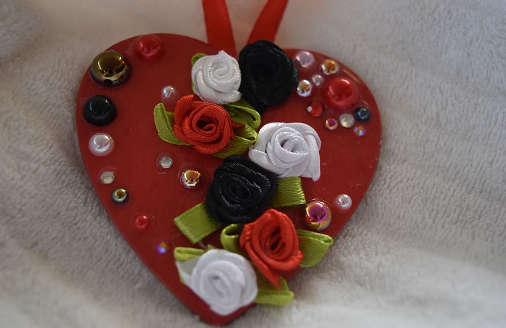 A red heart with white, black and pink roses.