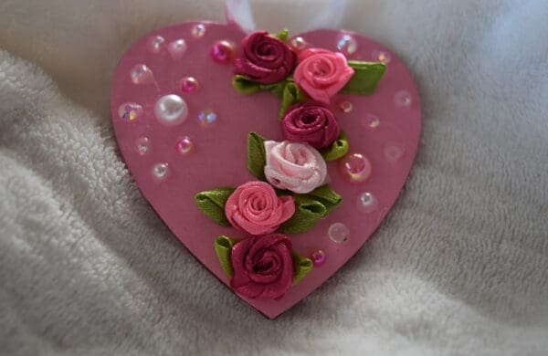 A pink heart with roses on it