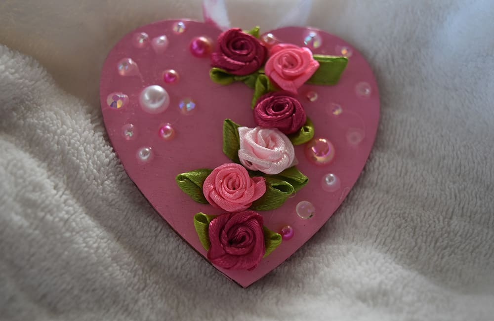 A pink heart with roses on it