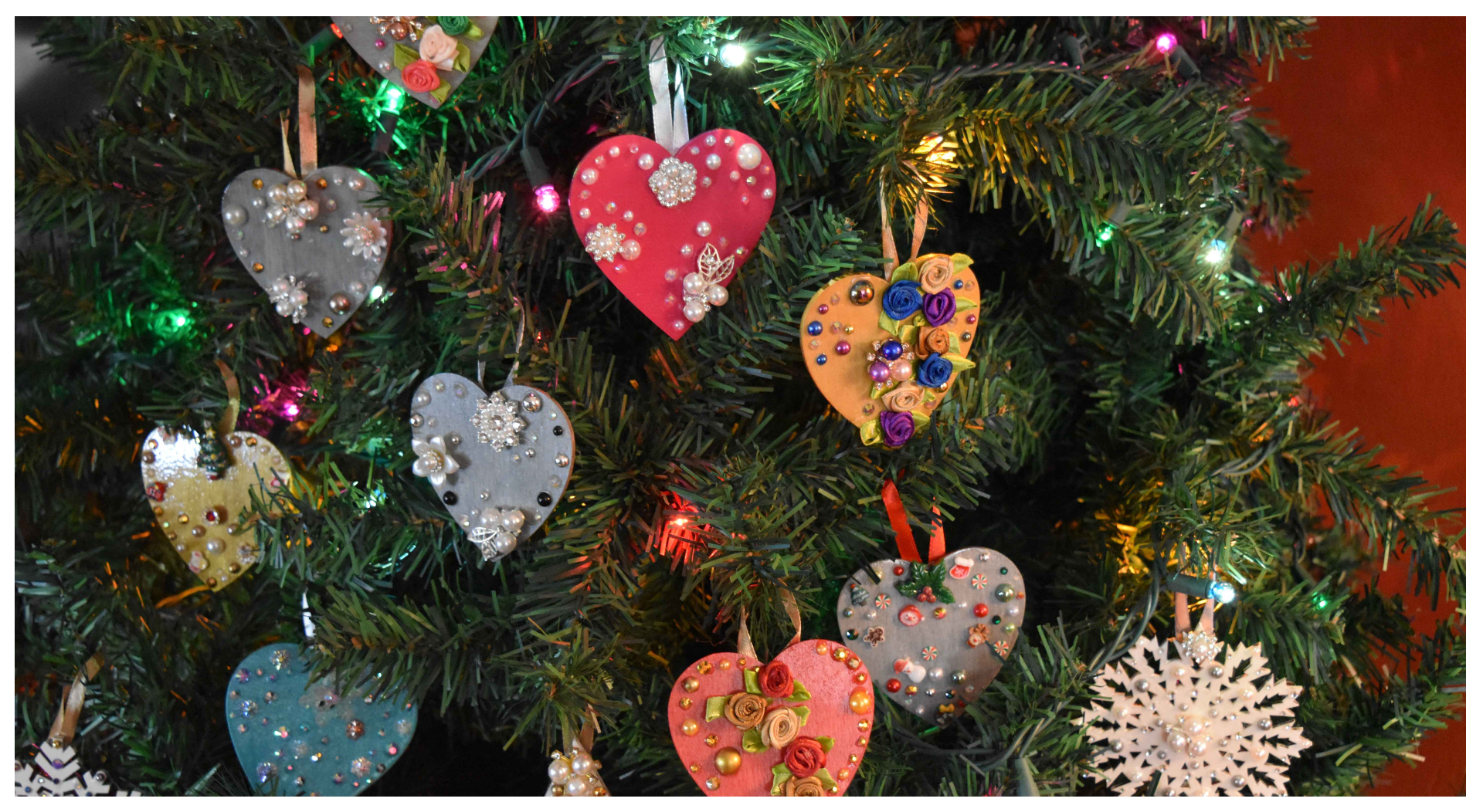 A close up of some hearts hanging on a christmas tree